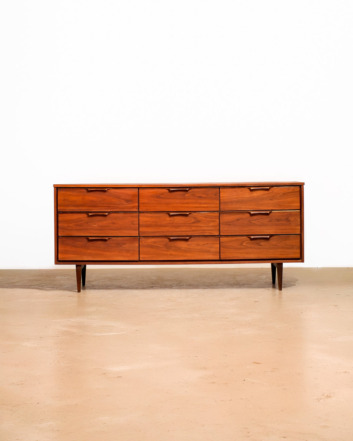 Mid-century modern dark walnut restored dresser on a plain white background — rich walnut grain