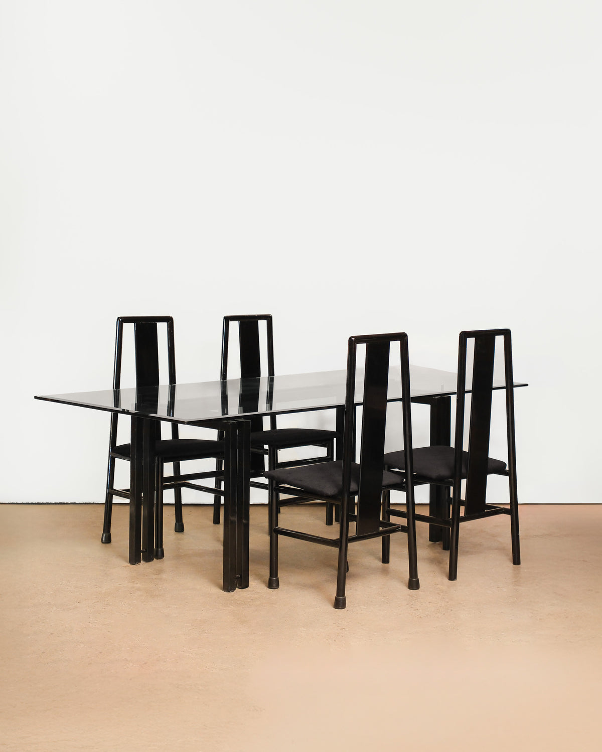 Postmodern Italian black lacquered dining set on a plain white background — bold sculptural lines