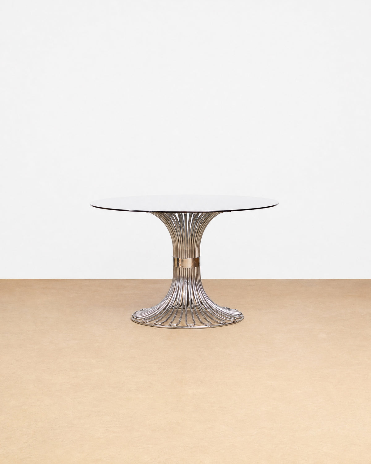 Postmodern smoked glass and chrome dining table by Gastone Rinaldi on a plain white background — sculptural chrome base