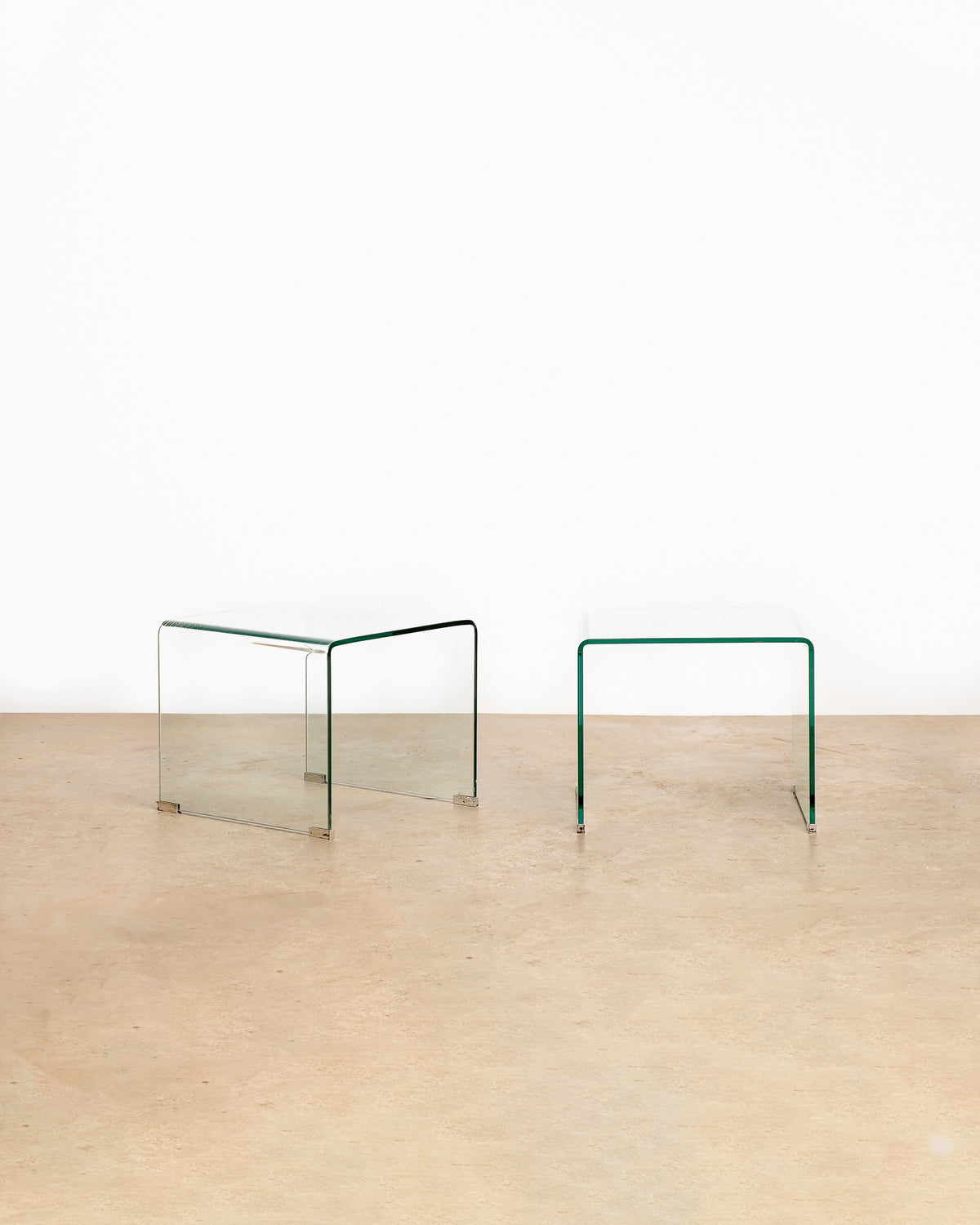 Glass waterfall coffee table and side table set on a plain white background — curved waterfall edge