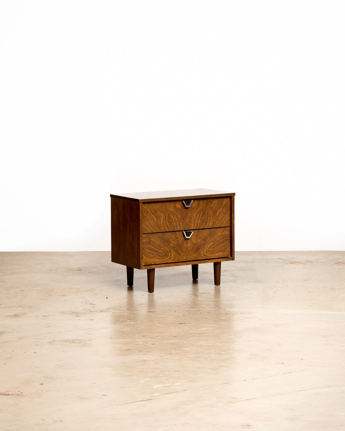 Mid-century modern walnut nightstand by Treco on a plain white background — rich walnut grain