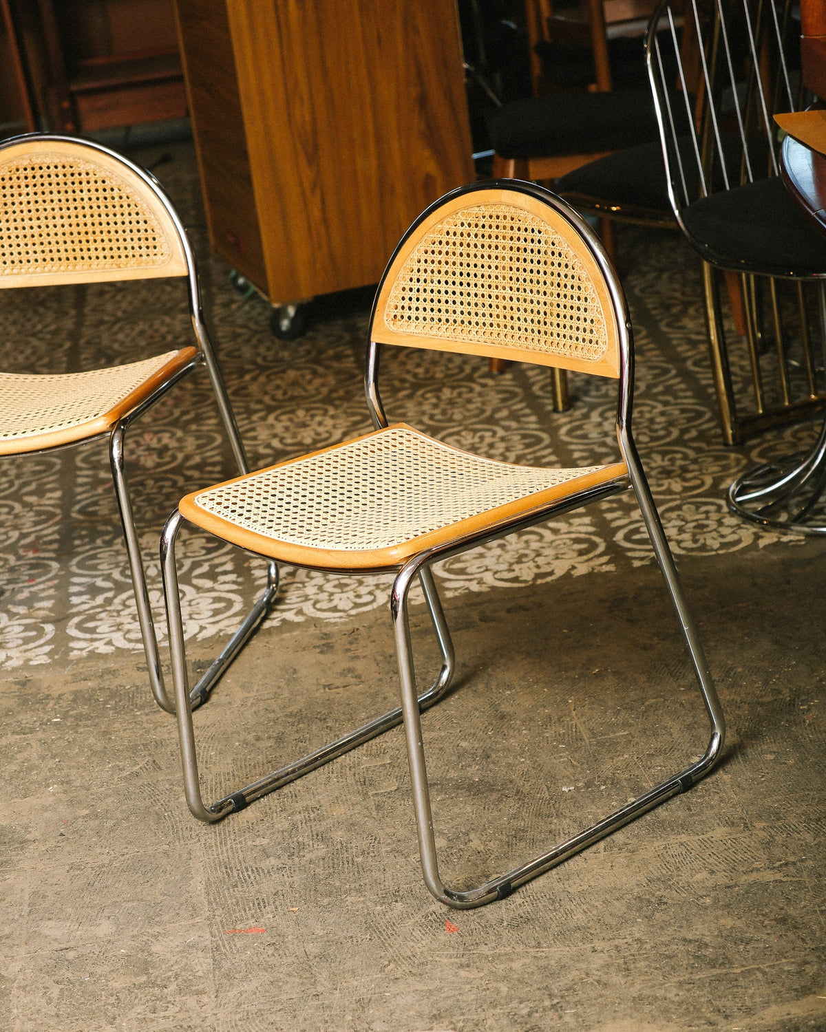 Close angle of a cane chair showing the curved caned backrest and seat detail
