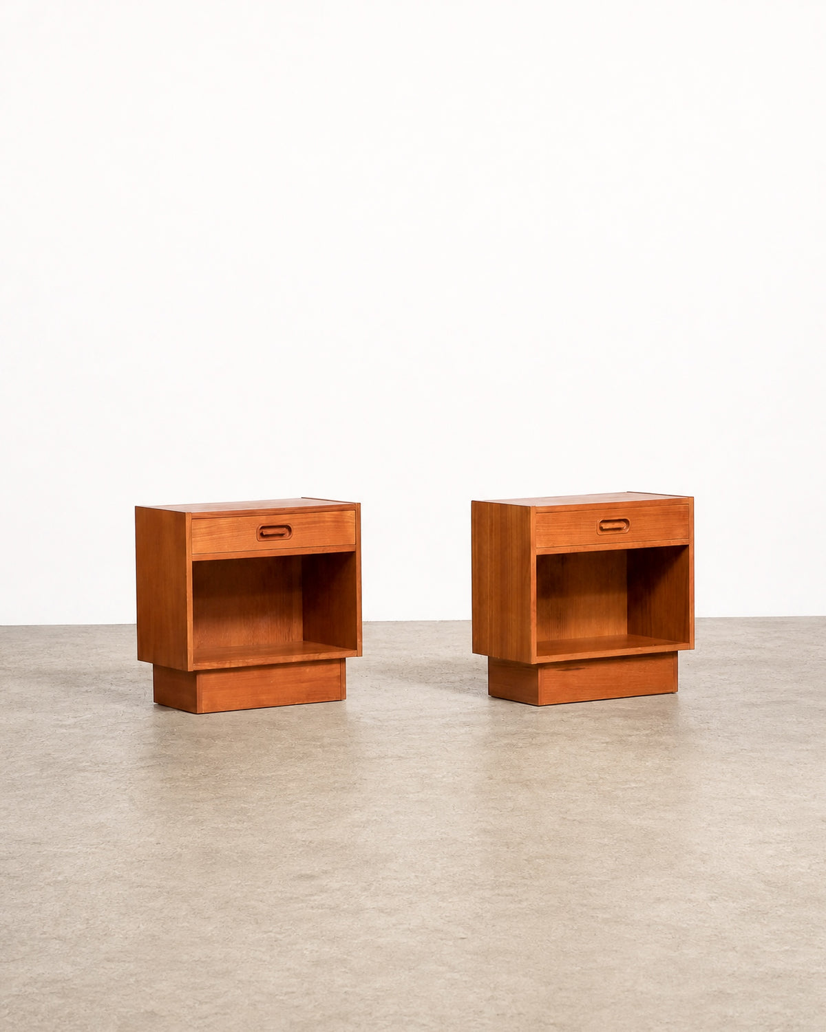 Mid-century modern Danish teak nightstand set by Dyrlund on a plain white background — rich teak grain and refined Danish craftsmanship