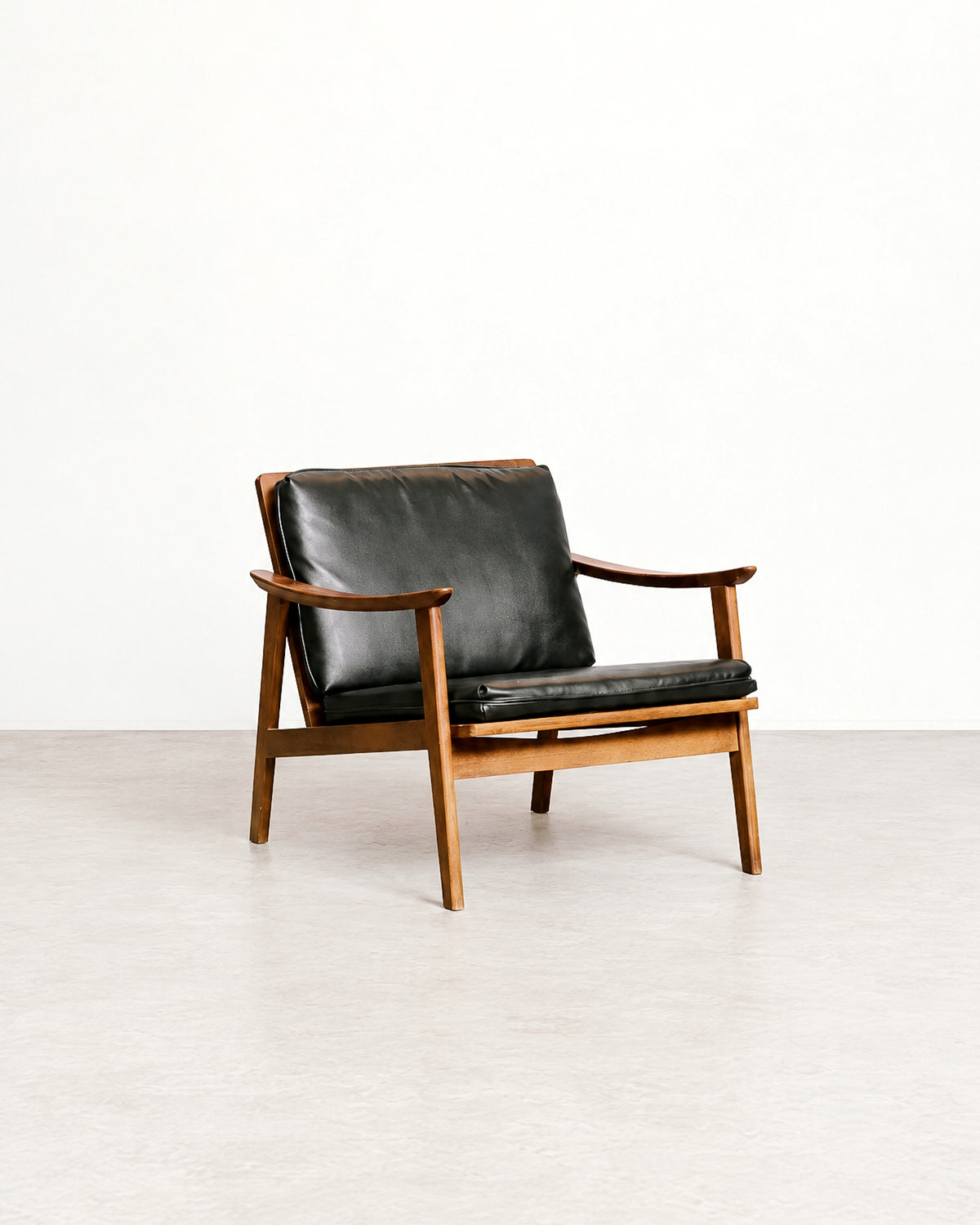 Rear angle of the lounge chair highlighting the frame construction and cushion placement.