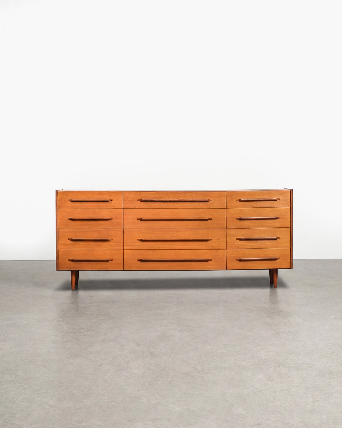 Mid-century modern teak 12-drawer dresser on a plain white background — restored rich teak grain and Scandinavian design