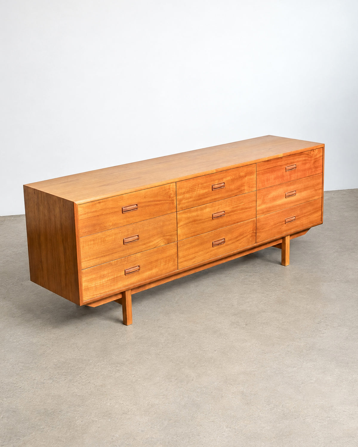 Additional angle of the teak dresser showing the overall proportions and drawer arrangement.