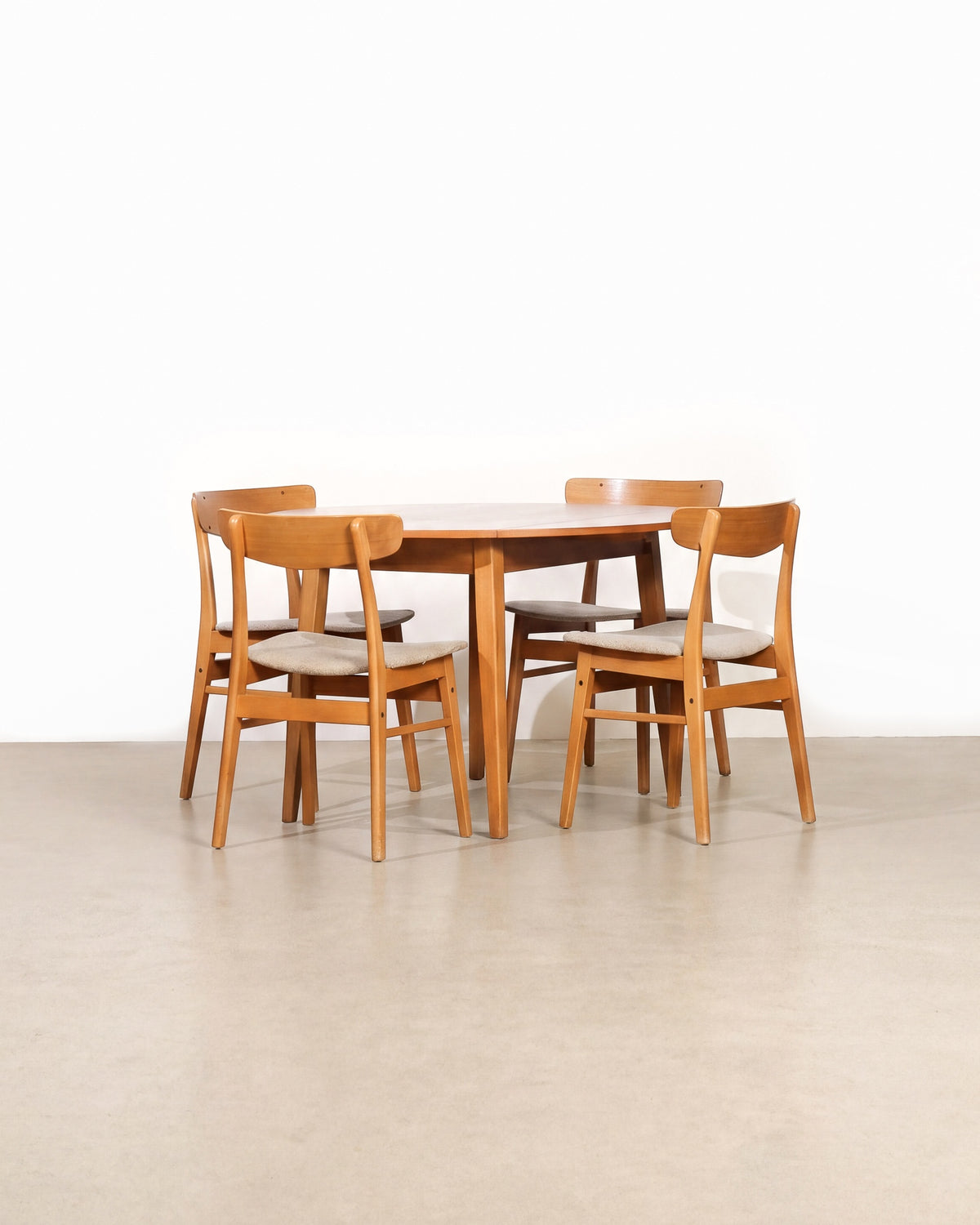 Mid-century modern teak dining set with 4 chairs on a plain white background — rich teak grain and Scandinavian-inspired lines