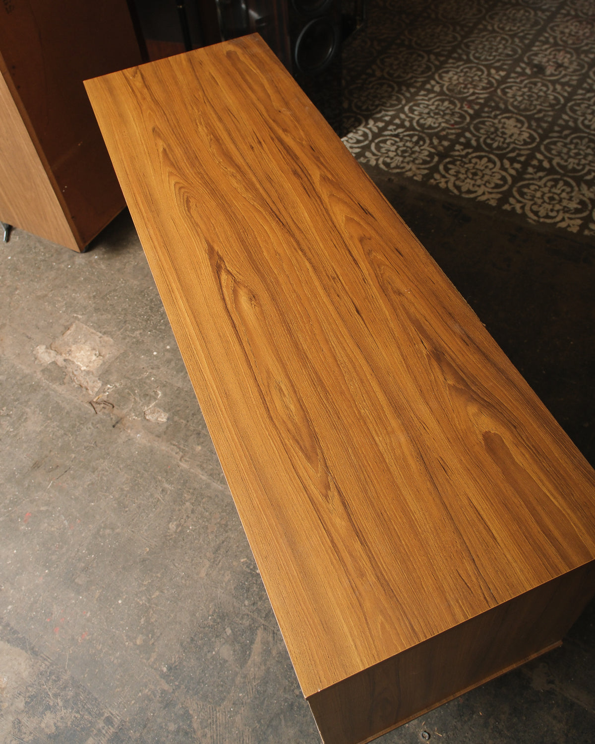 Overhead view of the teak top showing natural grain pattern and clean edges.