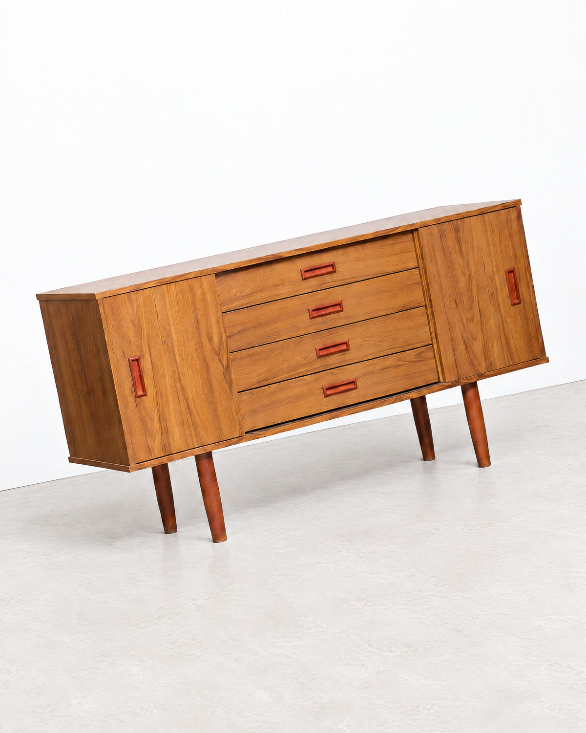 Detail shot highlighting the sculpted handle hardware and drawer fronts.