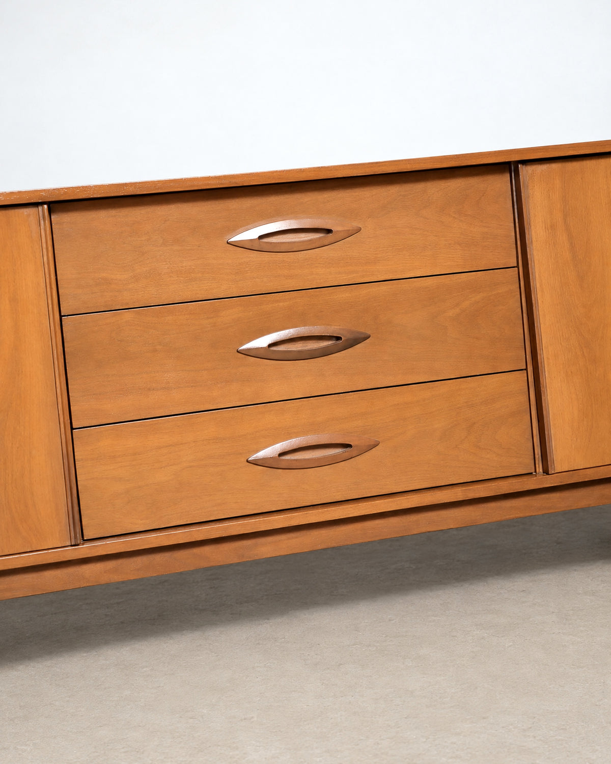 Wide shot of the dresser in the showroom among other vintage furniture.