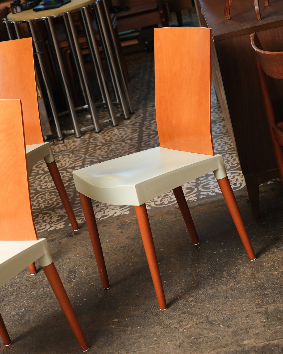 Side view of a Miss Trip chair showing the cream seat and tall bentwood back among other vintage furniture.