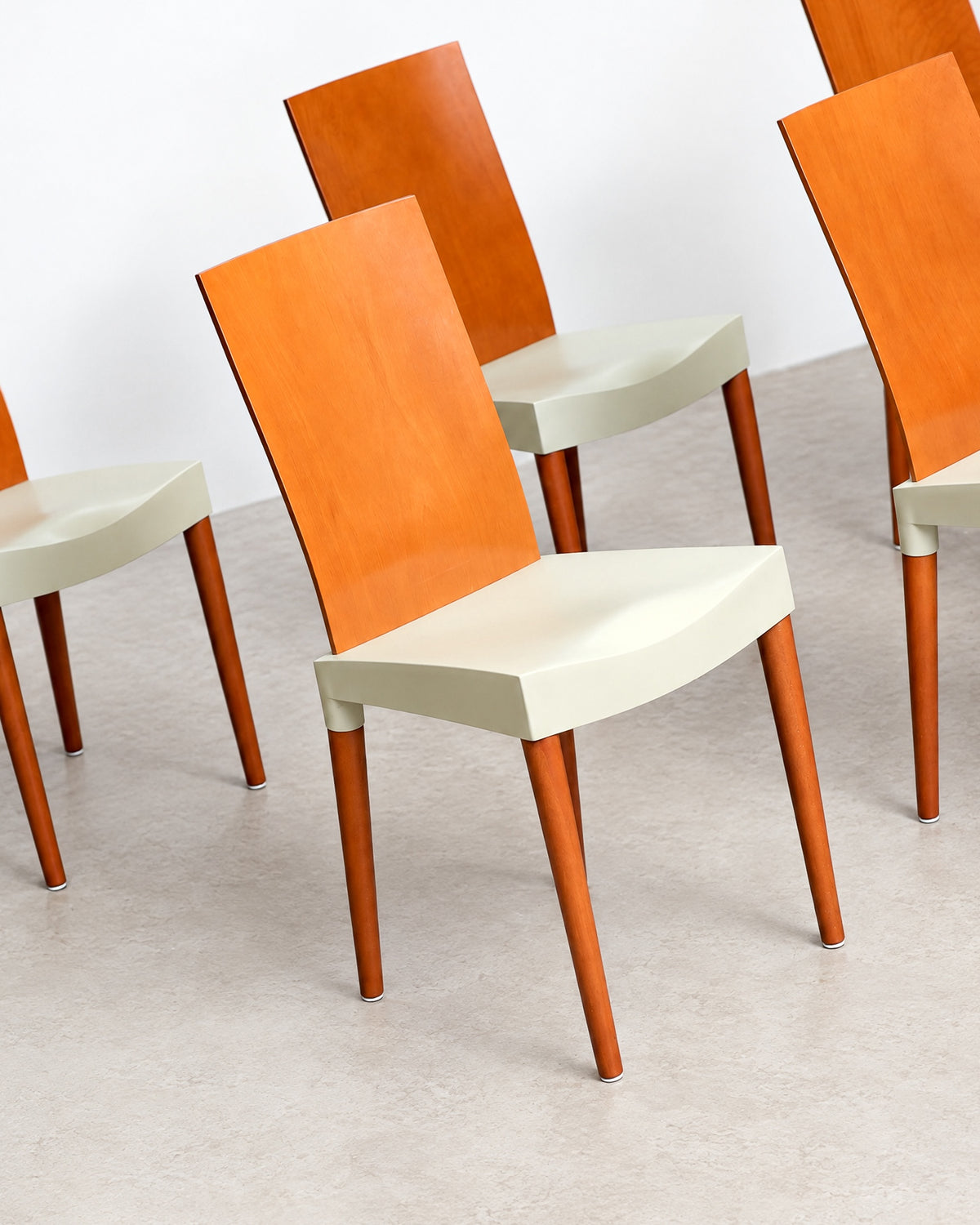 Detail of the chair leg and foot cap against the floor.