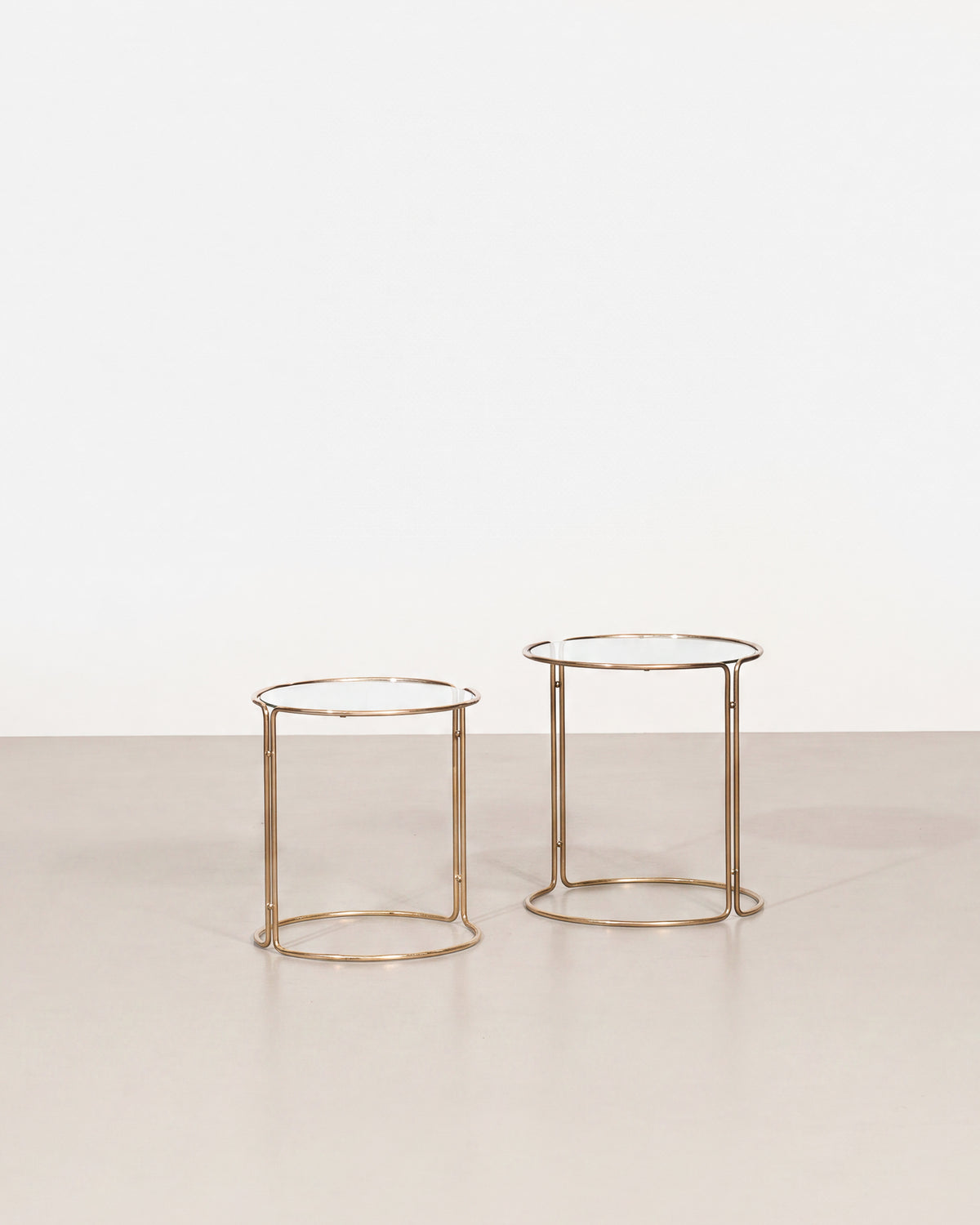 Vintage glass side table set on a plain white background — two coordinating tables with clean lines