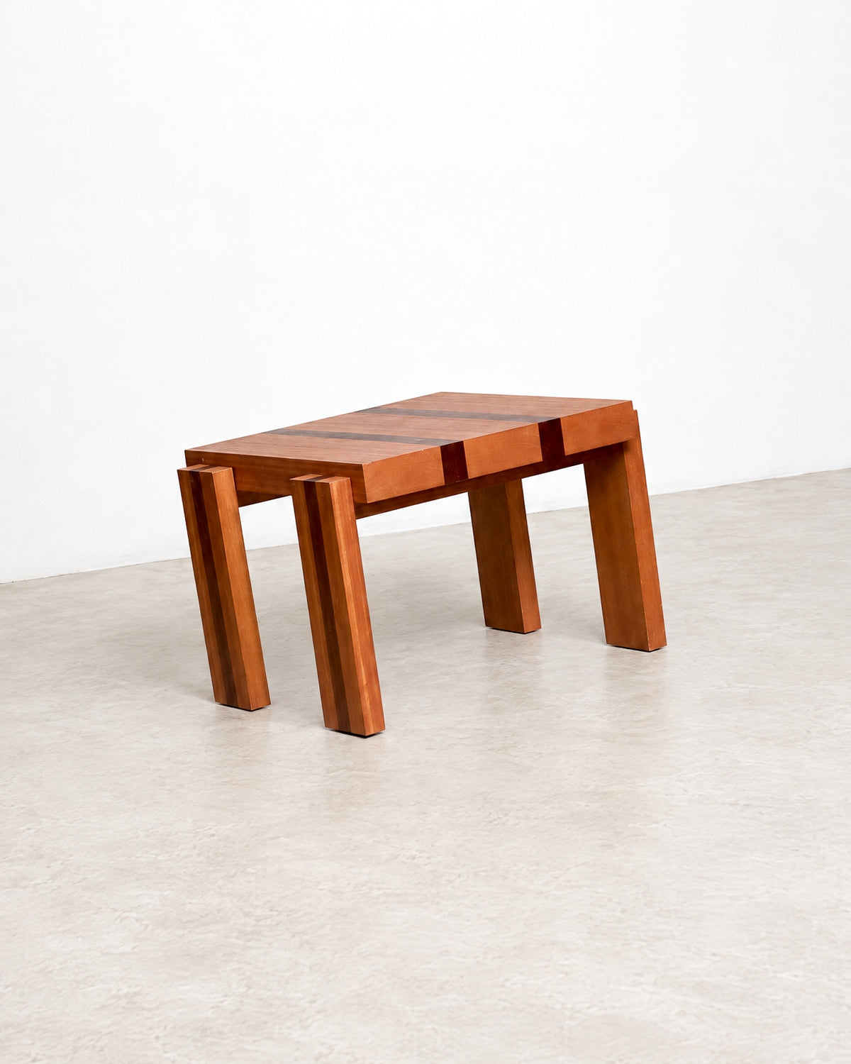 Three-quarter studio view of the coffee table showing its square form and tapered legs.