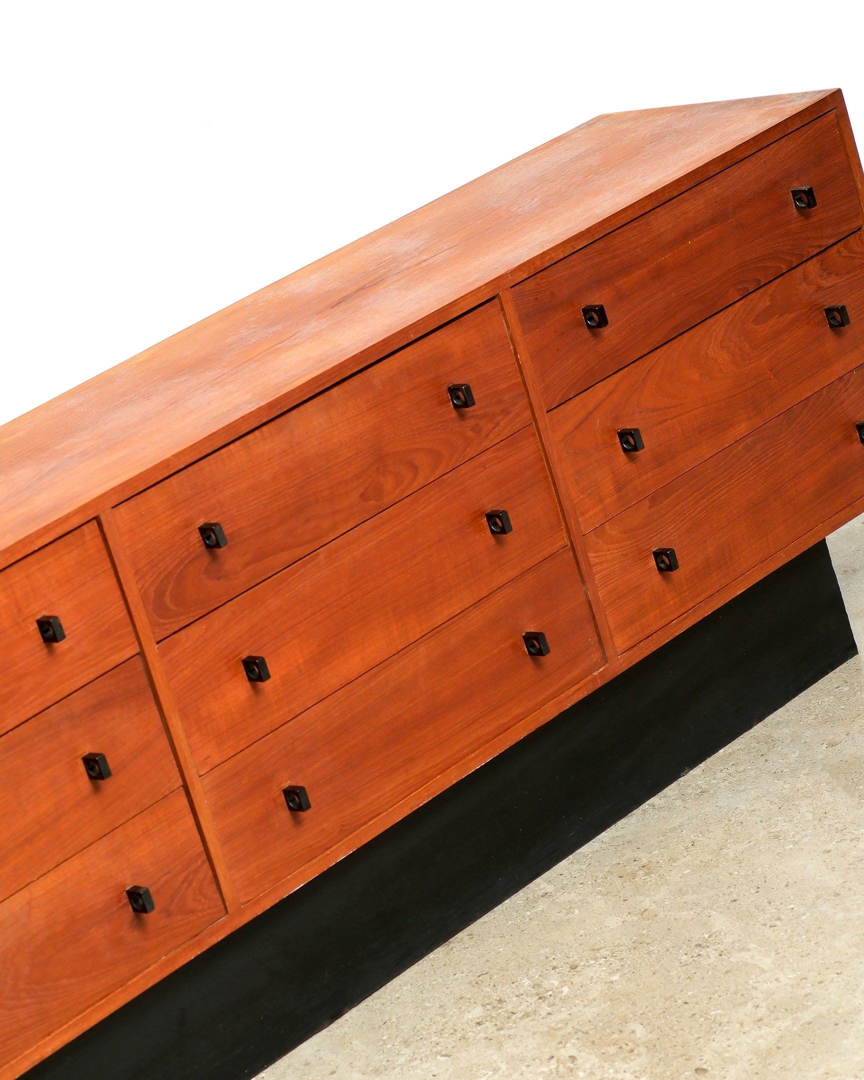 Wooden dresser with multiple drawers on a white background