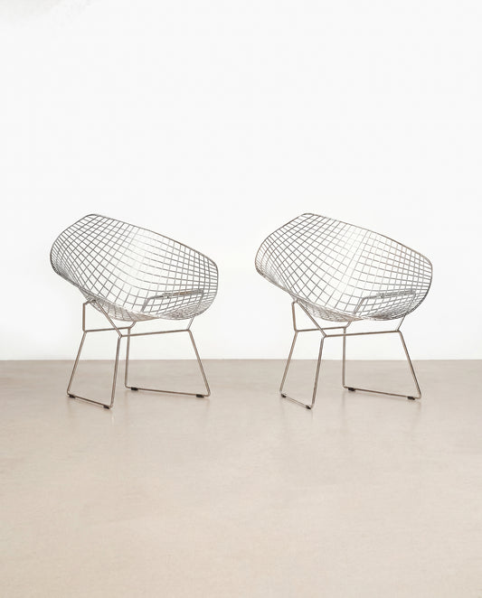 Two wireframe chairs on a plain white background