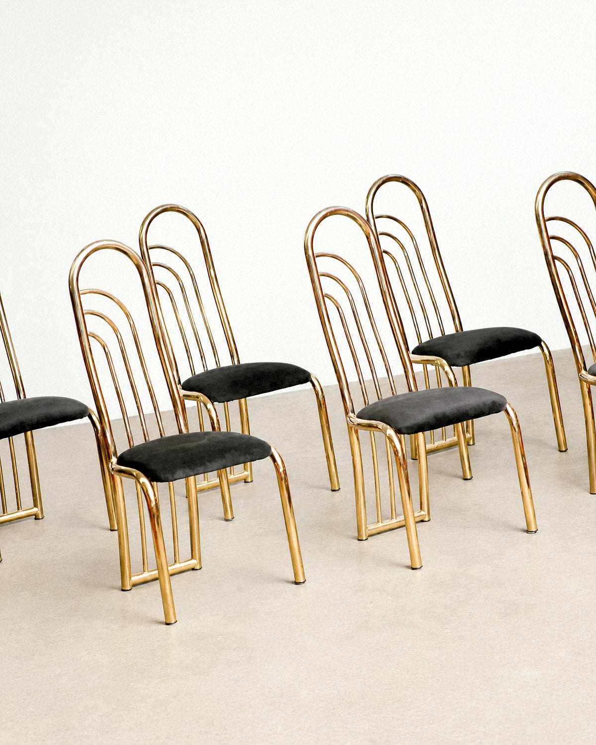 Front view of the brass dining chair showing the full fanned back and tapered legs.