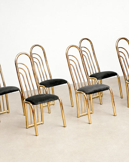 Front view of the brass dining chair showing the full fanned back and tapered legs.