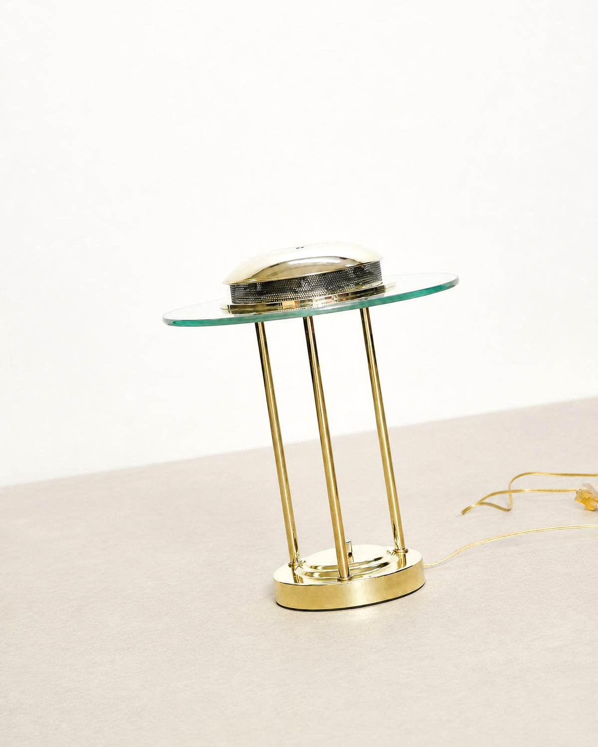 Studio shot of the brass saturn lamp against a plain background showing full silhouette.