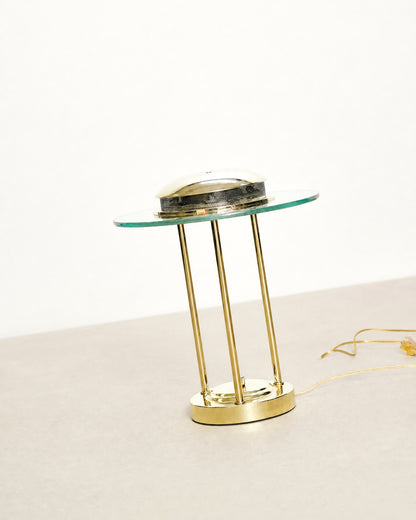 Studio shot of the brass saturn lamp against a plain background showing full silhouette.