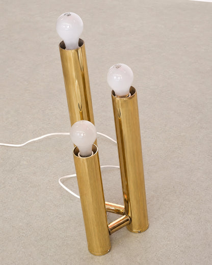 Overhead view of the brass table lamp on a plain background showing the base and cord