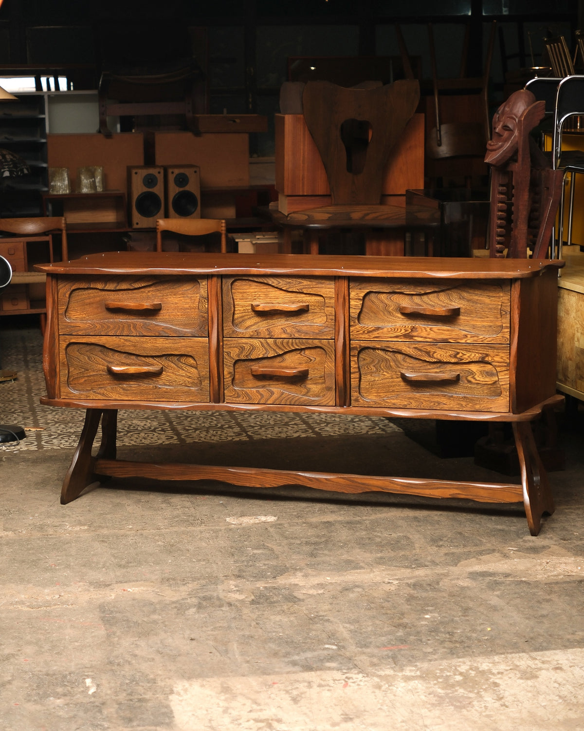Front view of vintage brutalist oak 9-drawer dresser with hand-sculpted wave-carved drawer fronts on a sled base.