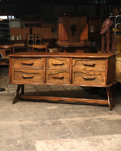 Front view of vintage brutalist oak 9-drawer dresser with hand-sculpted wave-carved drawer fronts on a sled base.