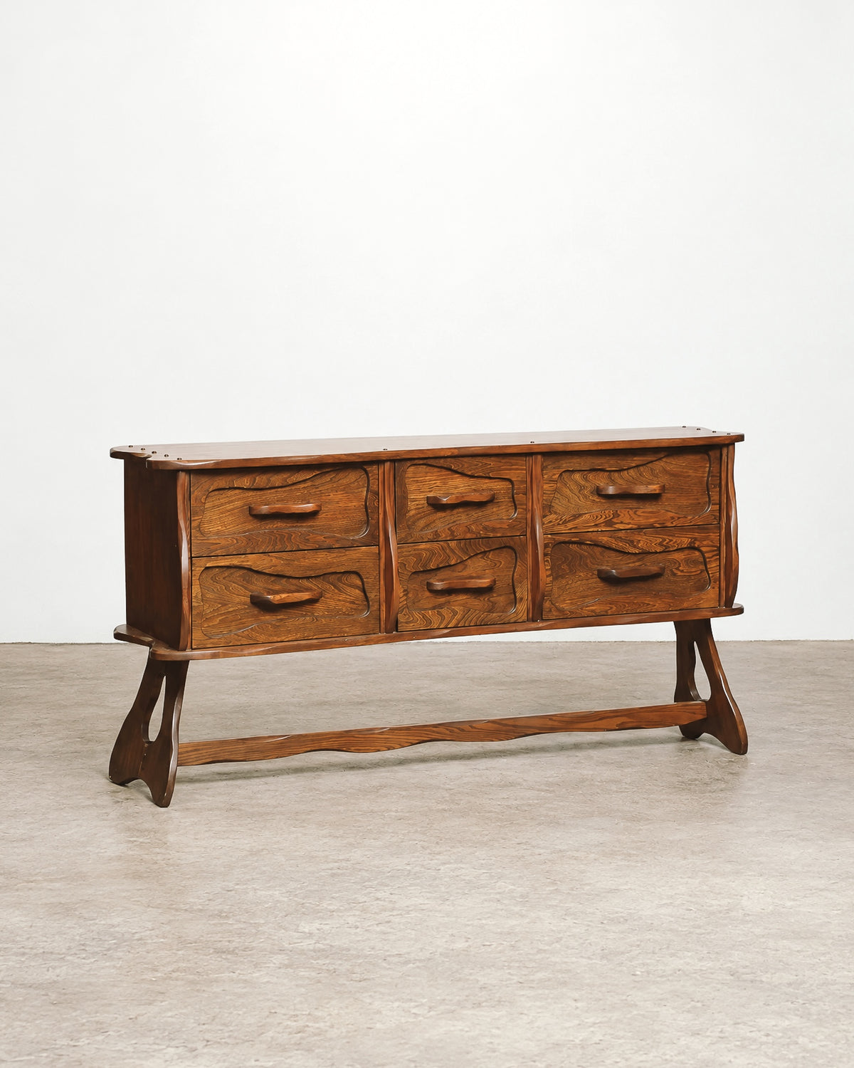Full side profile of the vintage brutalist oak dresser showing its overall form.
