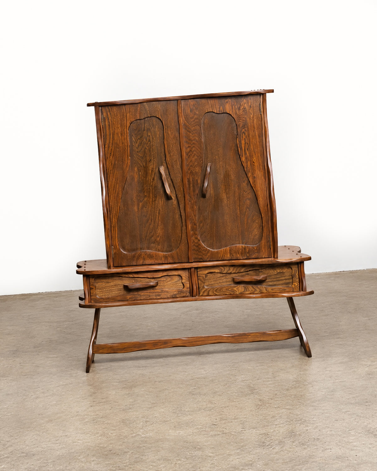 Front three-quarter view of the closed cabinet on a white background, showing the top edge and stretcher.