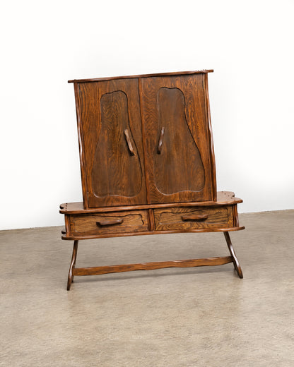 Front three-quarter view of the closed cabinet on a white background, showing the top edge and stretcher.