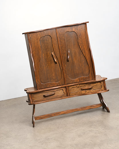 Side view of the cabinet showing depth, trestle legs, and stretcher construction.