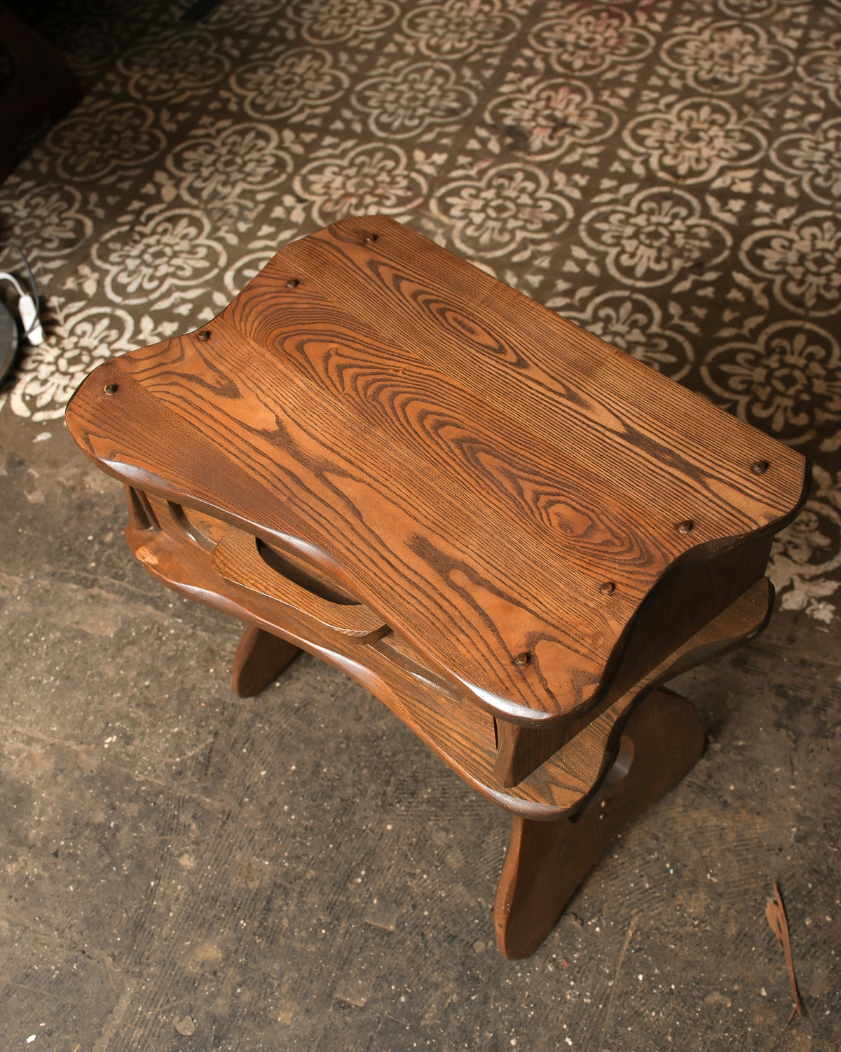 Overhead view highlighting the oak grain, peg details, and sculpted top edges.