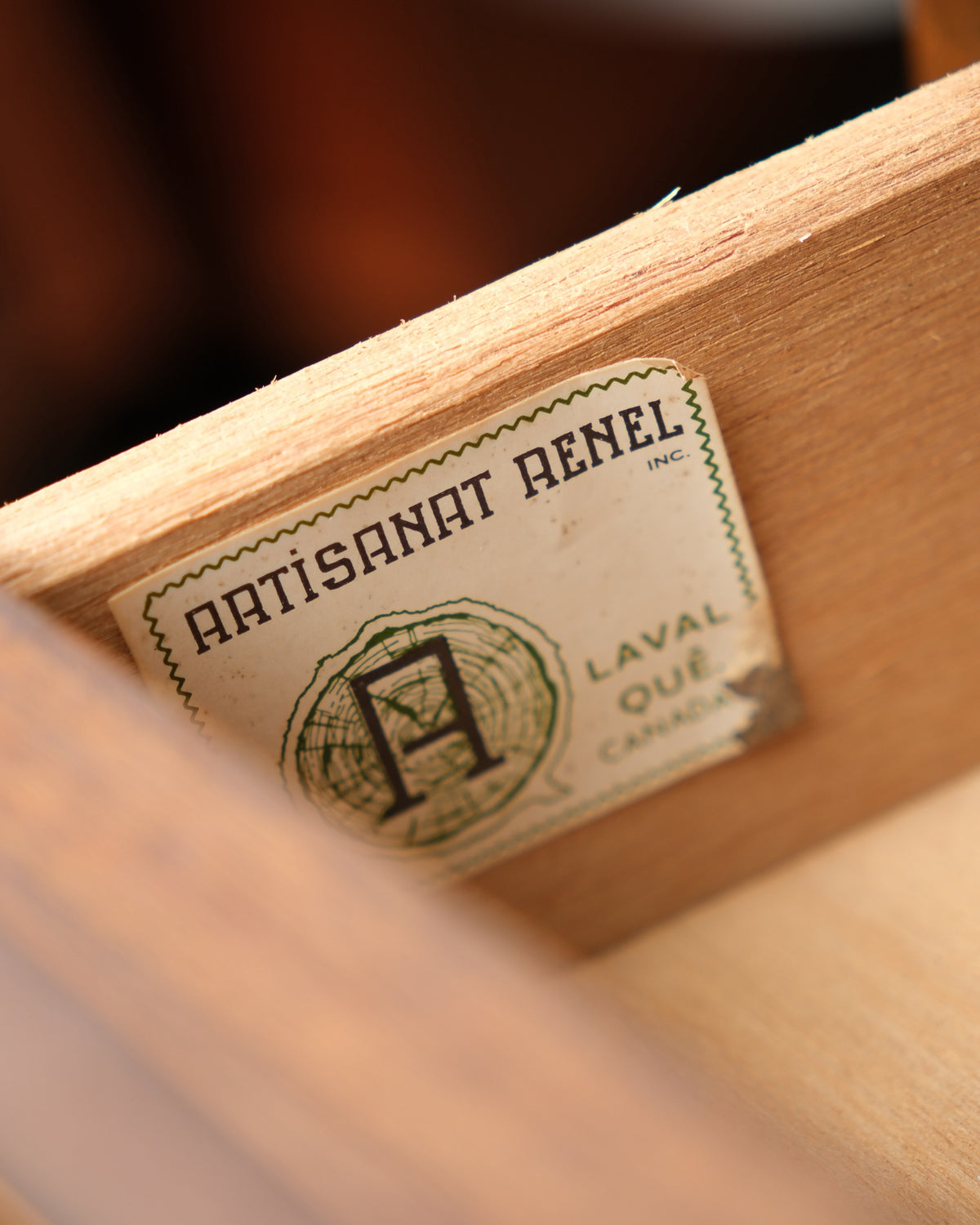 Close-up of the wood grain and carved detailing on one cabinet door.