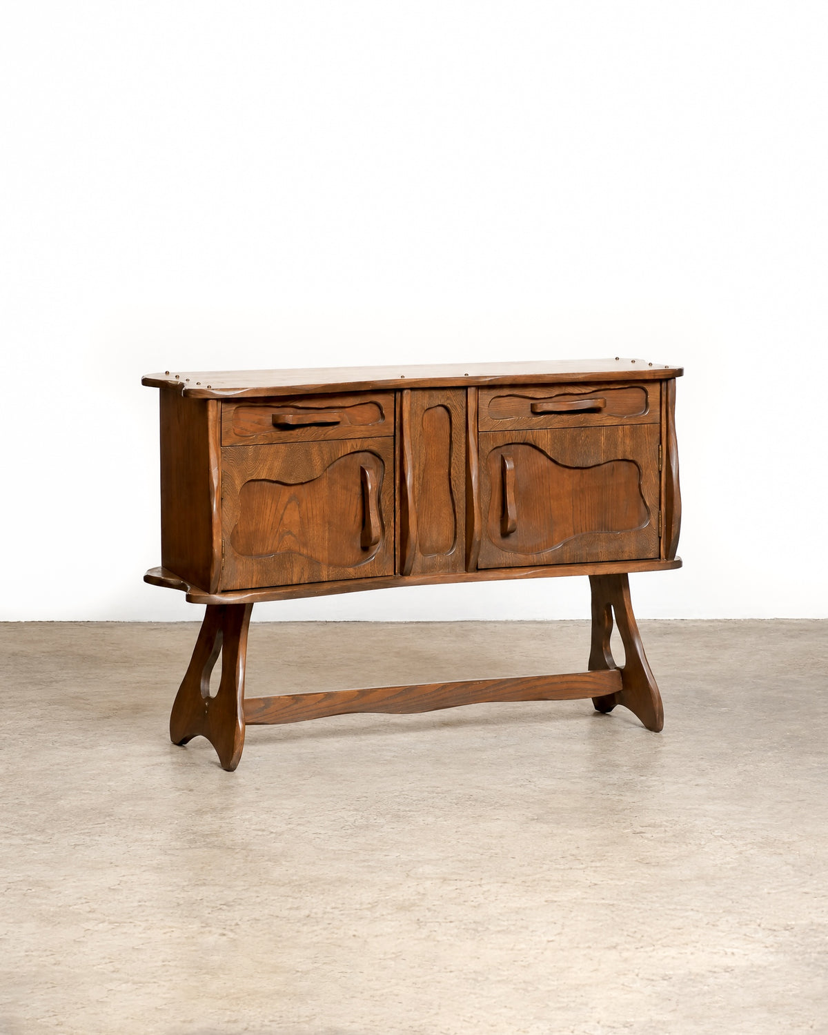Overall view of the sideboard among other vintage furniture in the shop.