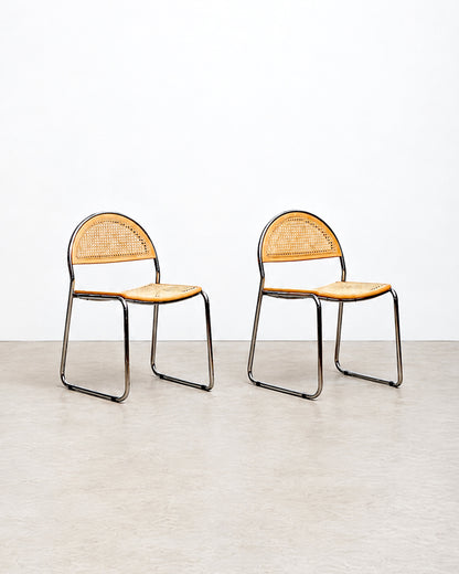 Studio side-by-side view of two cane chairs against a plain background