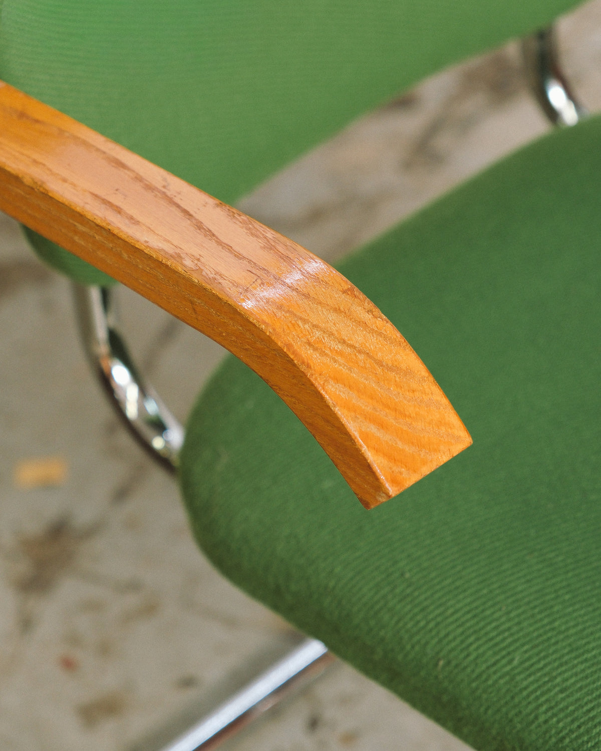 Detail of the bentwood armrest showing wood grain on the Cesca-style chair.