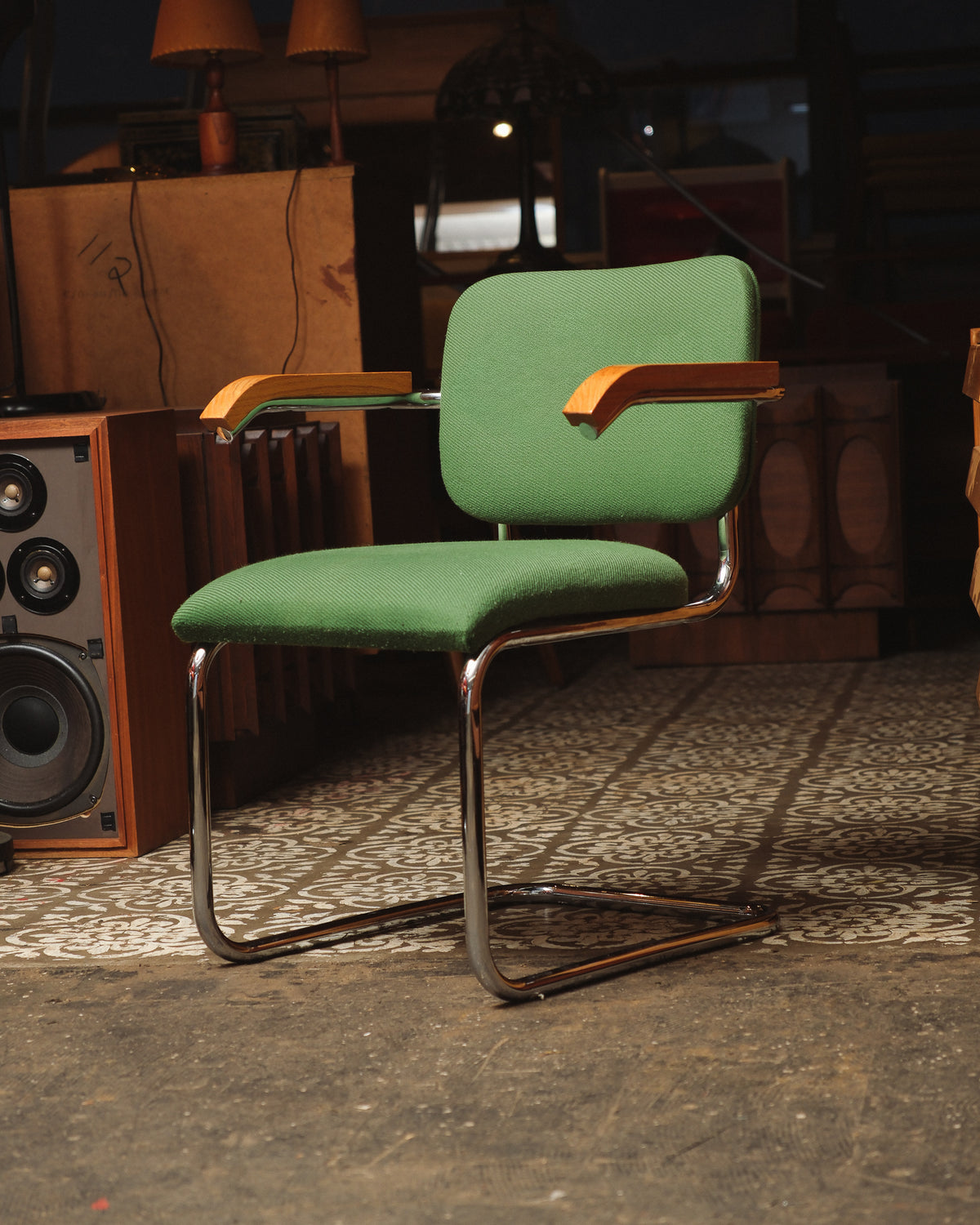 Side angle view of the Cesca-style chair highlighting the bentwood armrests and cantilevered base.