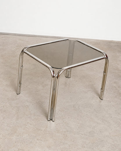 Overhead angle of the chrome coffee table showing the smoked glass top and tubular legs.