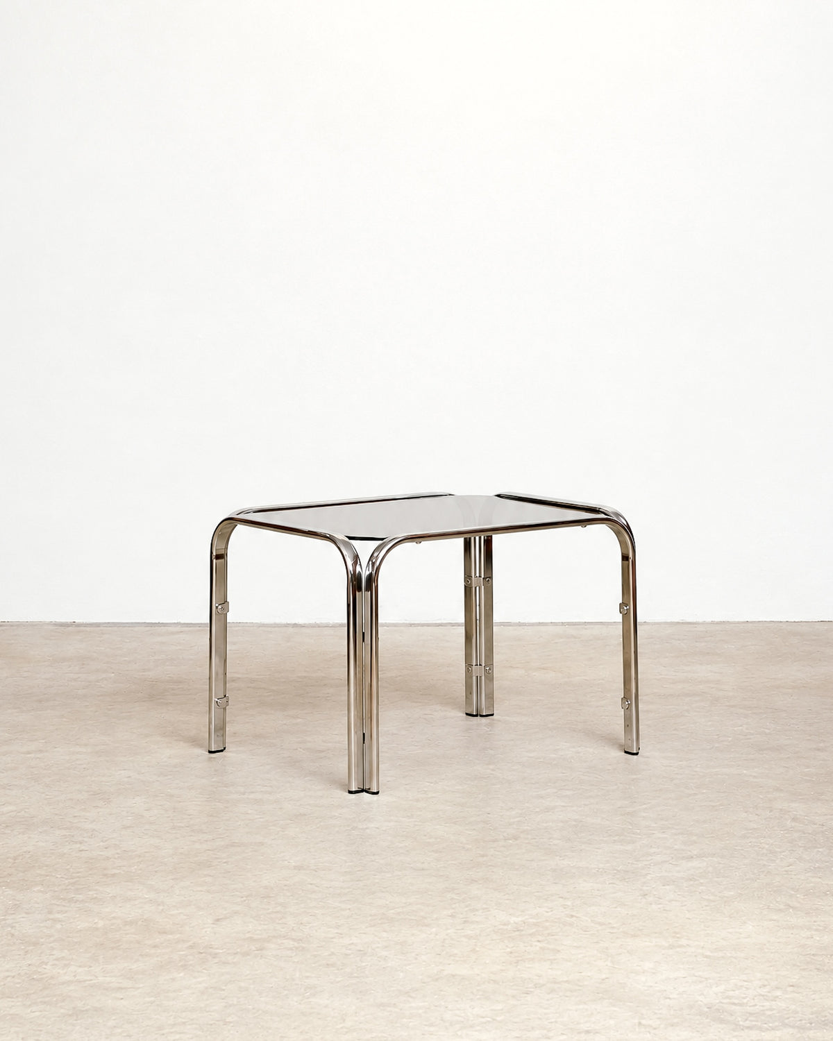 Additional angle of the vintage chrome coffee table showing the frame and glass top together.