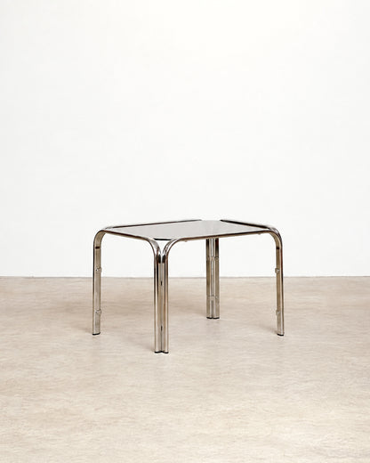 Additional angle of the vintage chrome coffee table showing the frame and glass top together.