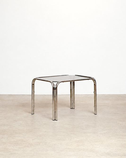Additional angle of the vintage chrome coffee table showing the frame and glass top together.