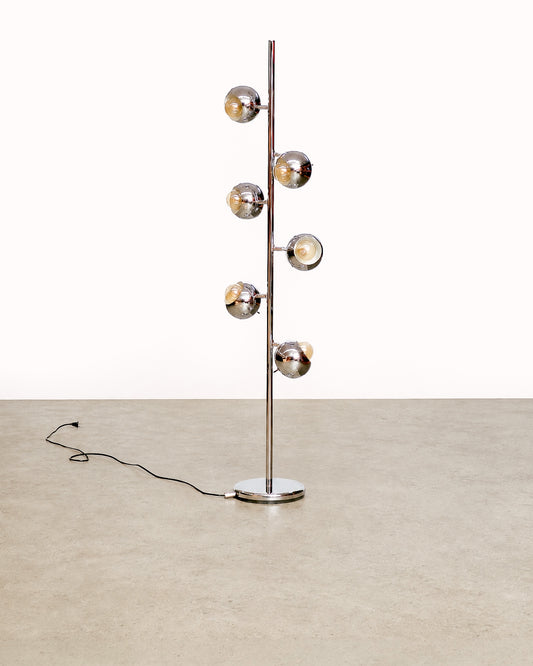 Front view of the vintage chrome floor lamp standing straight, showing the full height and base with cord.