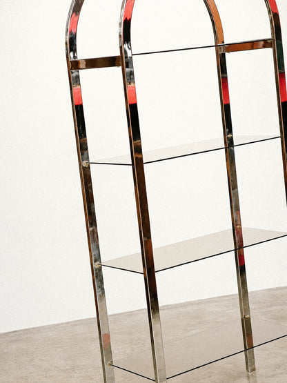 Detail view of the chrome frame and stacked smoked glass shelves from mid-height.