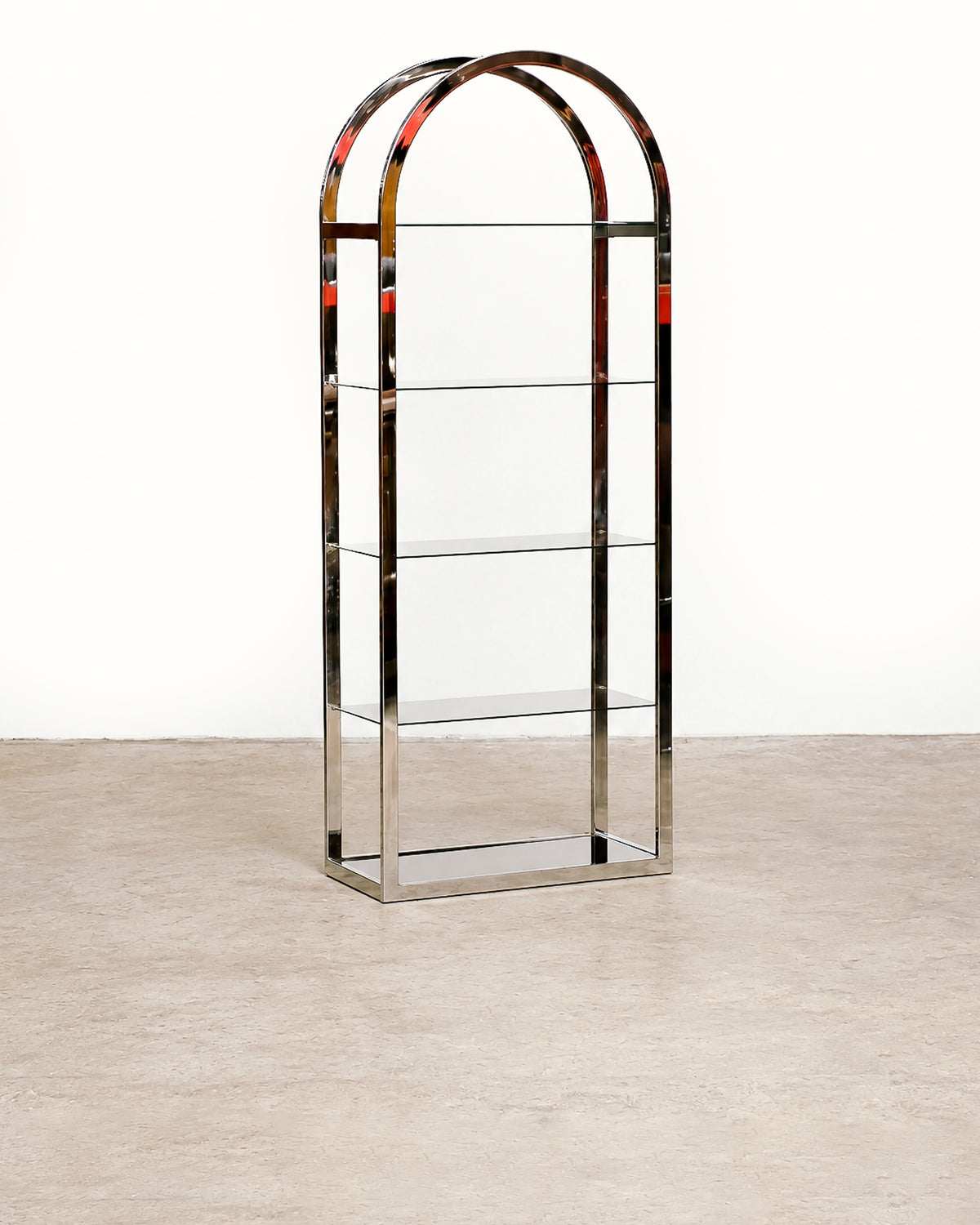 Straight-on front view of the chrome and smoked glass shelving unit showing its full arched silhouette.