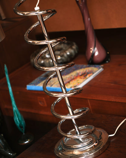 Close-up of the coiled chrome stem showing the spiral form and brushed metal base
