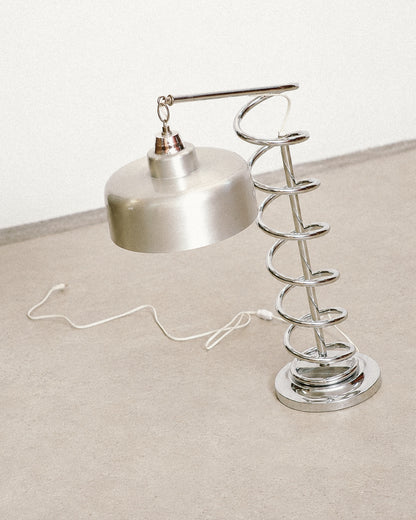 Angled view of the chrome spiral lamp highlighting the shade and adjustable arm