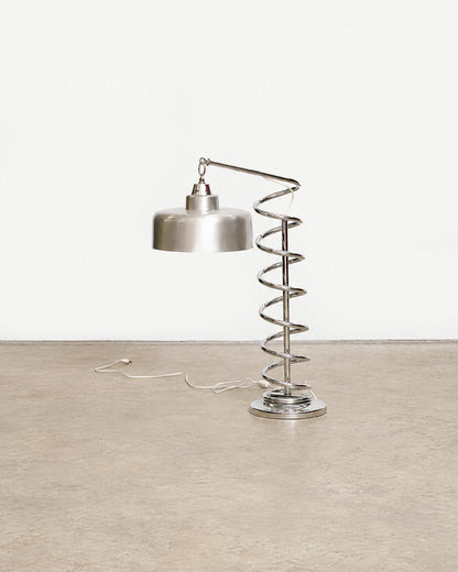 Front view of the chrome spiral table lamp against a plain backdrop showing overall form