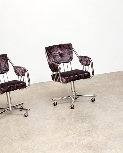 Side profile of chrome swivel armchair highlighting the tubular frame and wire seat back