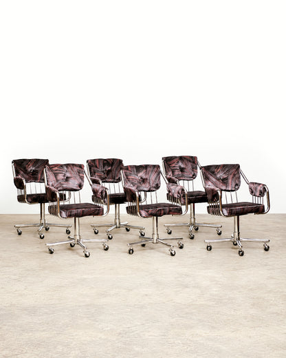 Close-up of chair base showing chrome cross legs and rolling casters