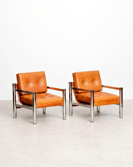 Three-quarter view of vintage chrome tubular leather chair with cognac leather cushions and chrome frame.